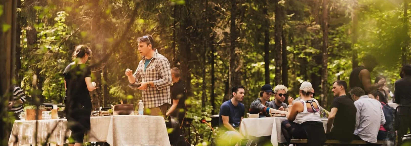 Chef cooking over an open fire at a pop-up dinner on the edge of a bog in Estonia