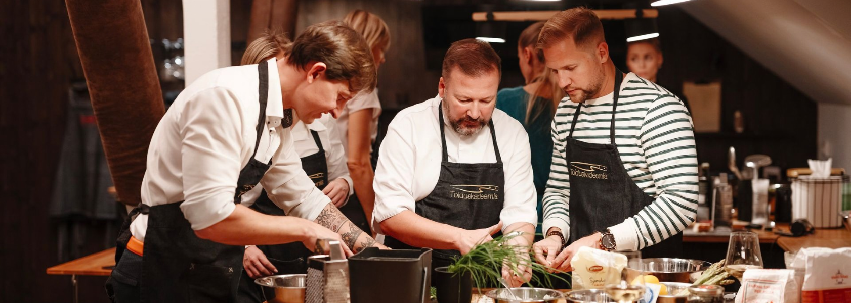 Team cooking together with a chef at a social cooking class in Tallinn